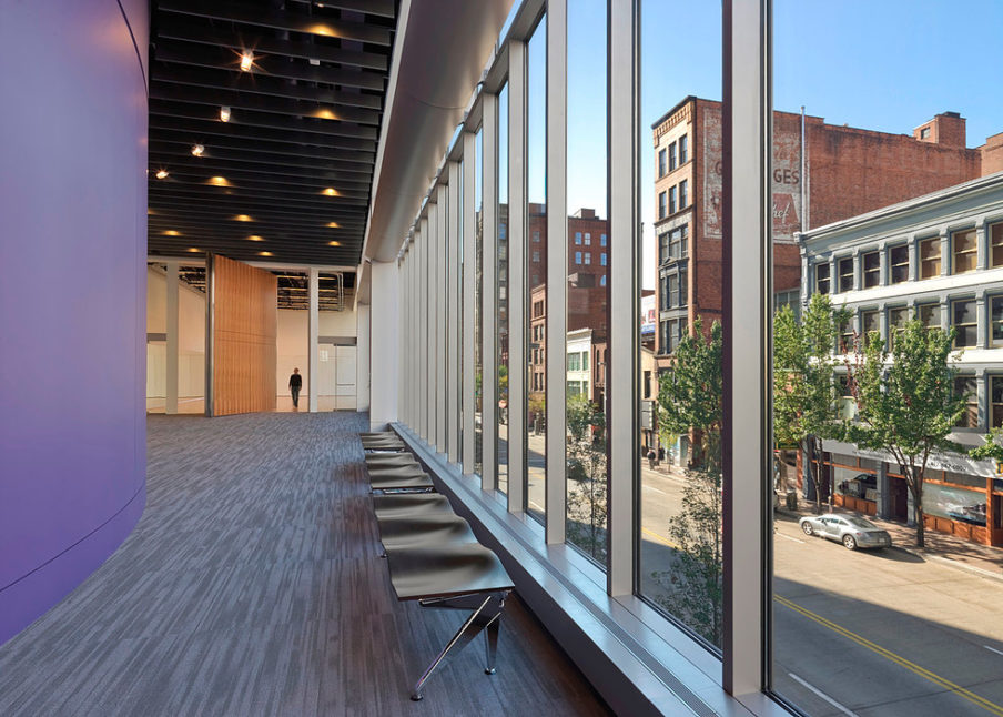 Inside & Out: Tall floor to ceiling windows create a partition between the building interior and the street.